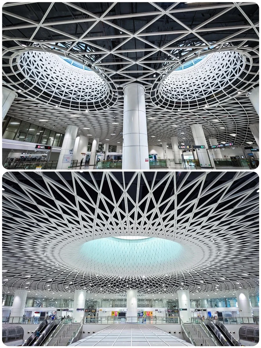 Modern geometric ceiling design inside Gangxia Bei Metro Station, featuring white lattice structures and circular skylights.