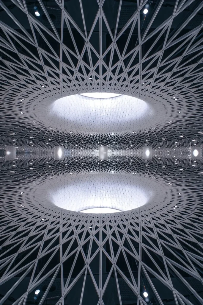 Close-up of the futuristic, geometric ceiling at Gangxia North Metro Station in Shenzhen, featuring concentric light wells an