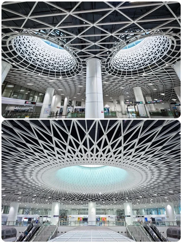 Modern geometric ceiling design inside Gangxia Bei Metro Station, featuring white lattice structures and circular skylights.
